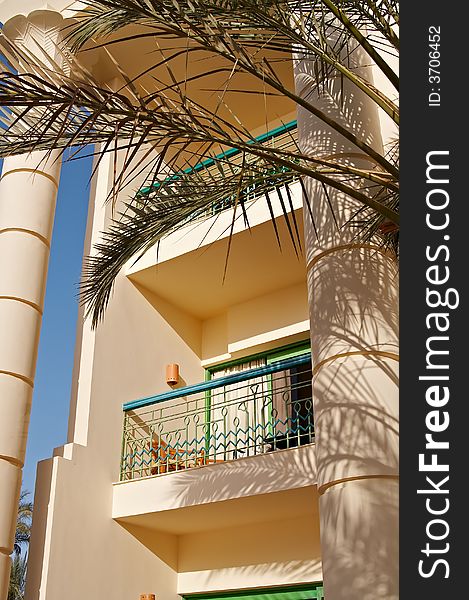 Hotel's balcony with palm leaves