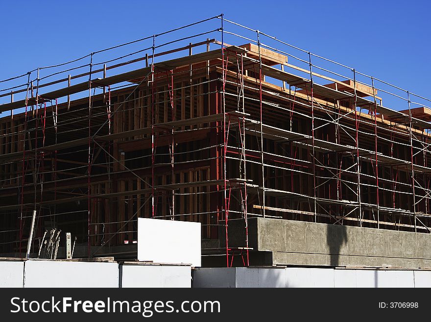 Building under construction with white sign for copy space on the bottom center. Building under construction with white sign for copy space on the bottom center