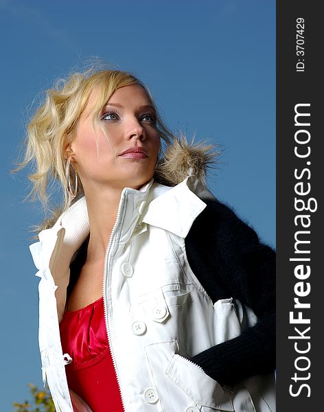 Portrait of a beautiful woman wearing winter coat over sky. Portrait of a beautiful woman wearing winter coat over sky