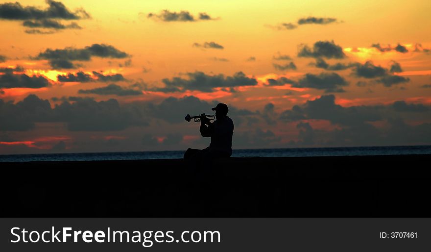 Lonely musician at sunset