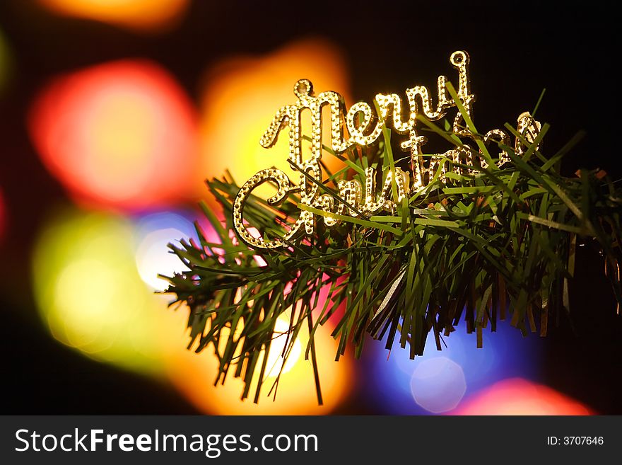 Merry cristmas phrase on a fir branch on colorful background. Merry cristmas phrase on a fir branch on colorful background