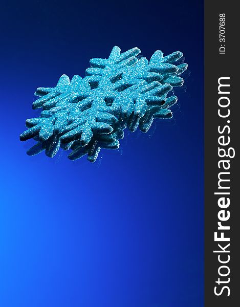 Artificial snowflake on a dark blue background