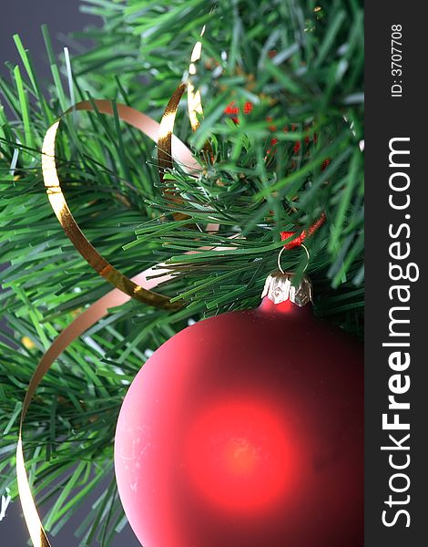 Red ball hanging from christmas tree.