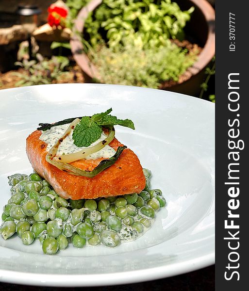 Baked salmon over fresh peas