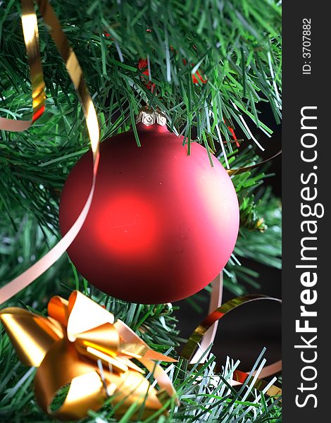 Red ball hanging from christmas tree