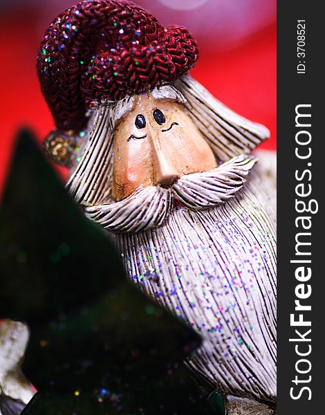 Wooden santa clause with cap and tree