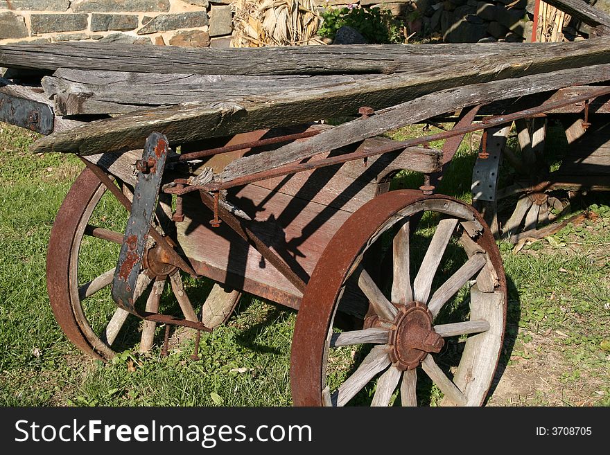 An old antique rusty horse drawn wagon for transporting. An old antique rusty horse drawn wagon for transporting