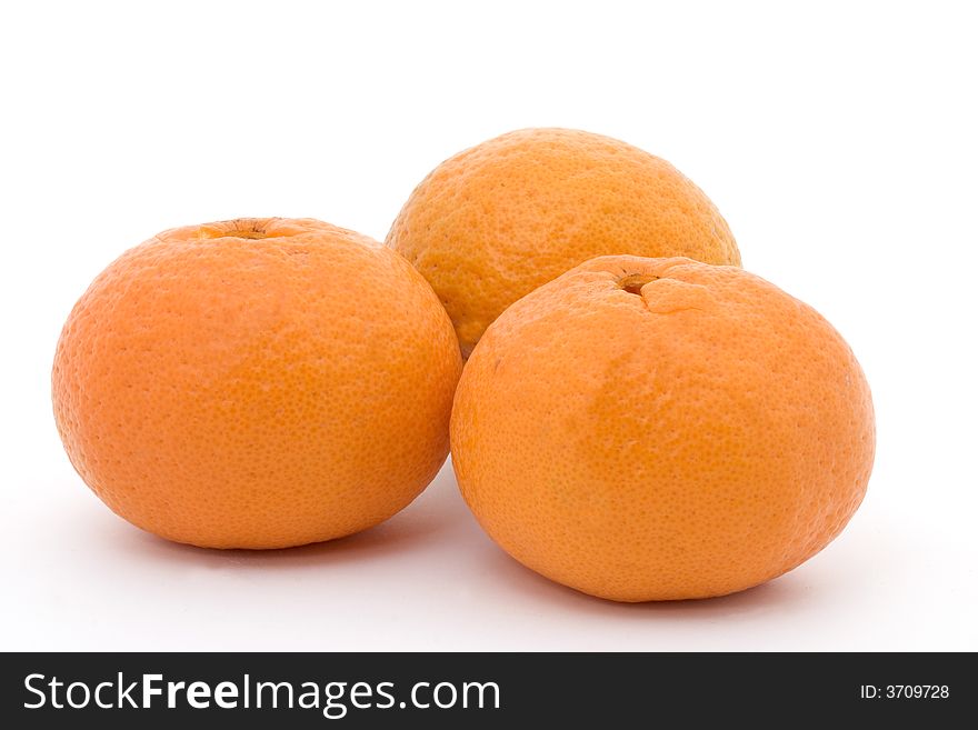 Three orange tangerines on a white background. Three orange tangerines on a white background
