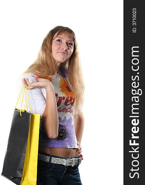 The beautiful high girl with a bag for purchases poses on a white background. The beautiful high girl with a bag for purchases poses on a white background