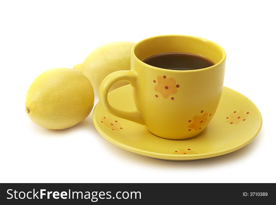 Yellow coffee cup and lemons isolated over white background