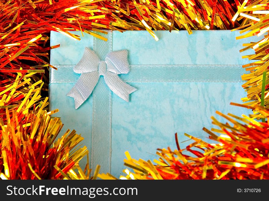 Blue Christmas gift with ribbon on colorful  decorations. Blue Christmas gift with ribbon on colorful  decorations