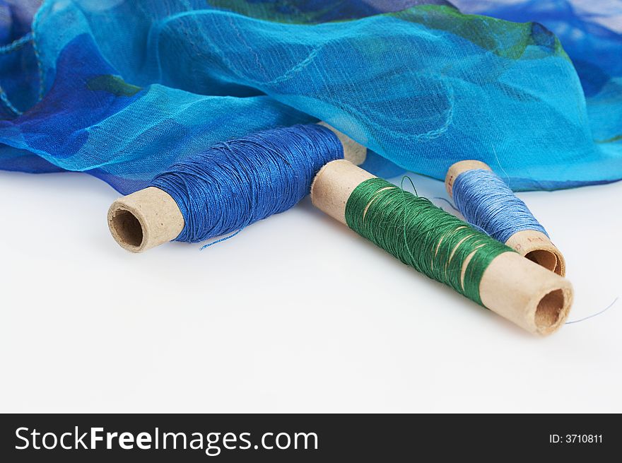 Delicate blueish silk scarfand matching threads. Delicate blueish silk scarfand matching threads