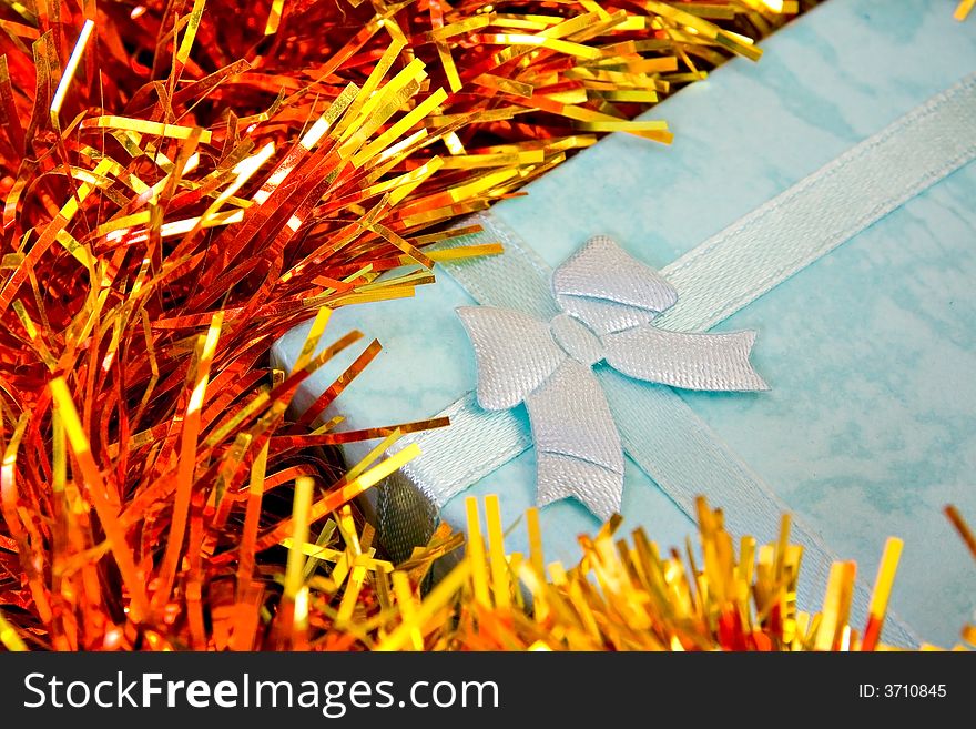 Blue Christmas gift with ribbon on colorful  decorations