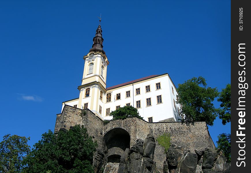 Medieval Czech castle standing on the rock with blue sky. Medieval Czech castle standing on the rock with blue sky