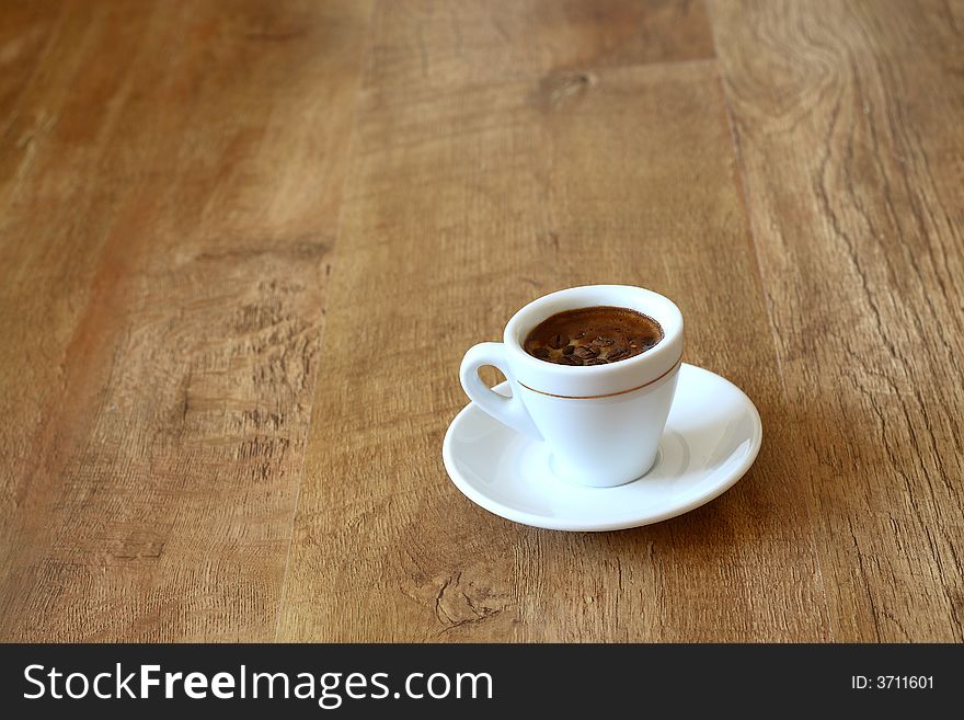 A cup of coffee on wood floor