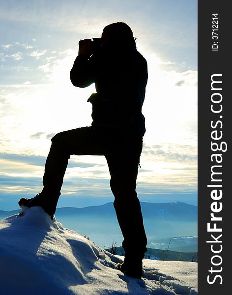 Silhouette of photographer on opposite of mountains. Silhouette of photographer on opposite of mountains