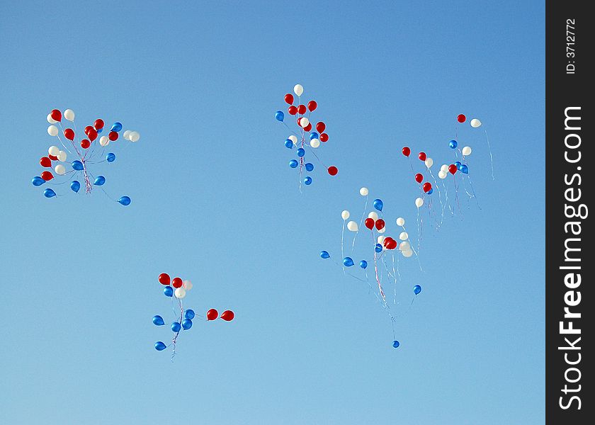 Red, white, dark blue balloons in the pure blue sky. Red, white, dark blue balloons in the pure blue sky