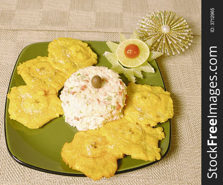 Crabmeat imitation salad with fried plantains and christmas decoration. Crabmeat imitation salad with fried plantains and christmas decoration