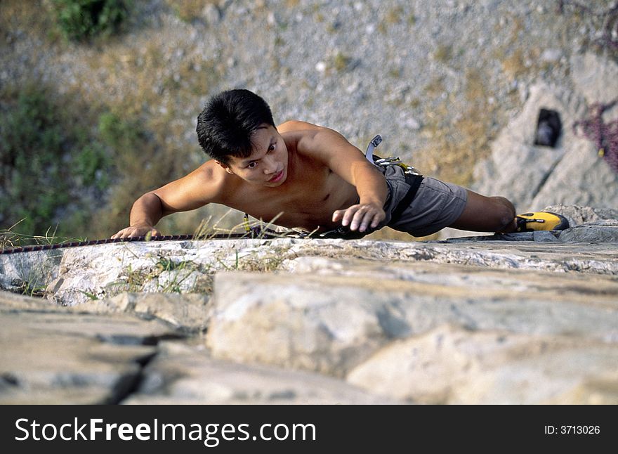 Climber ascending steep rocky wall.Beijing,China.