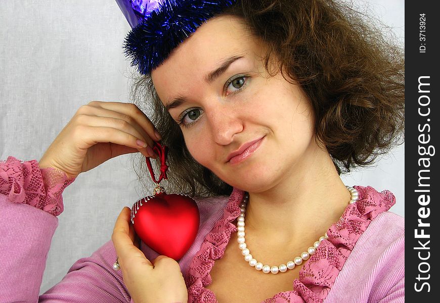 Woman and red heart looking at camera. Woman and red heart looking at camera