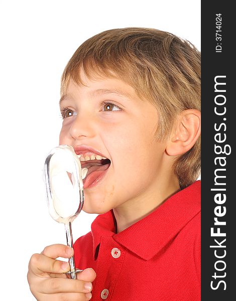 Shot of a happy kid licking frosting