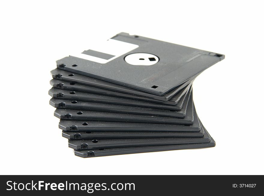 Pile of black diskettes on a white background.