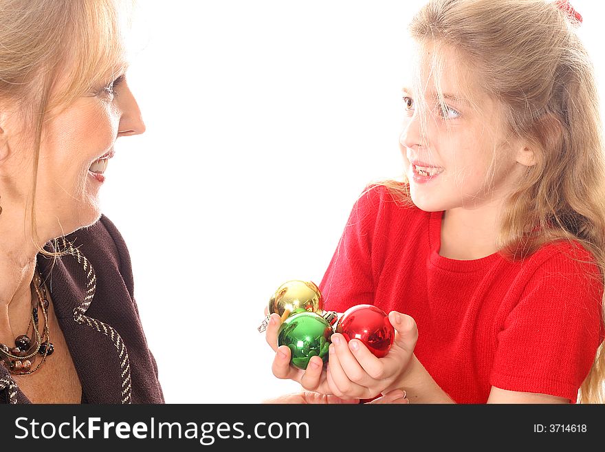 Shot of a child handing woman Christmas ornaments