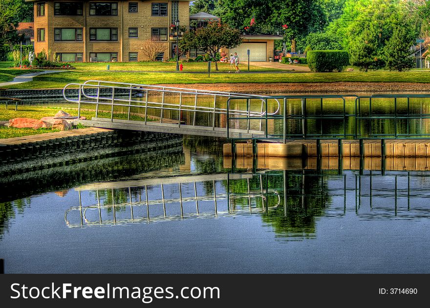 An HDR image of a floating dock, reflected in water.
