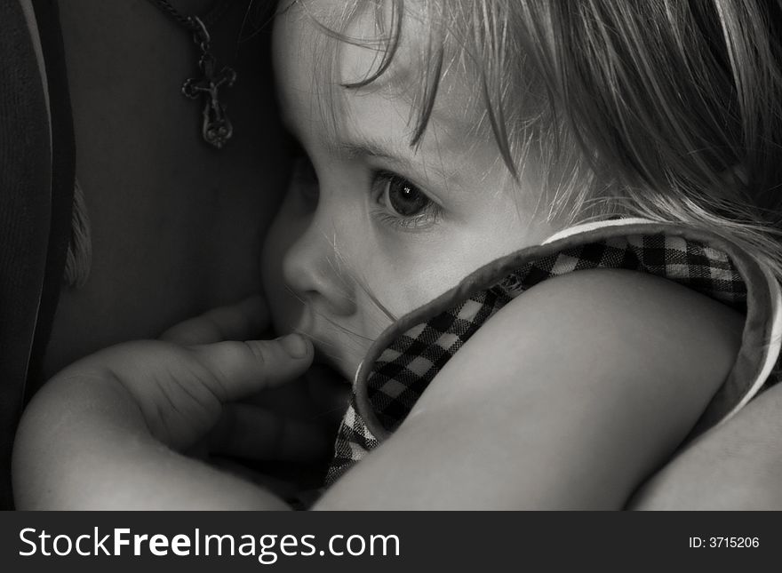 Black-and-white portrait of the girl at mother on hands