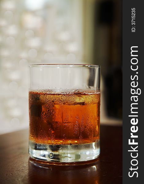 Glass of whisky with an ice