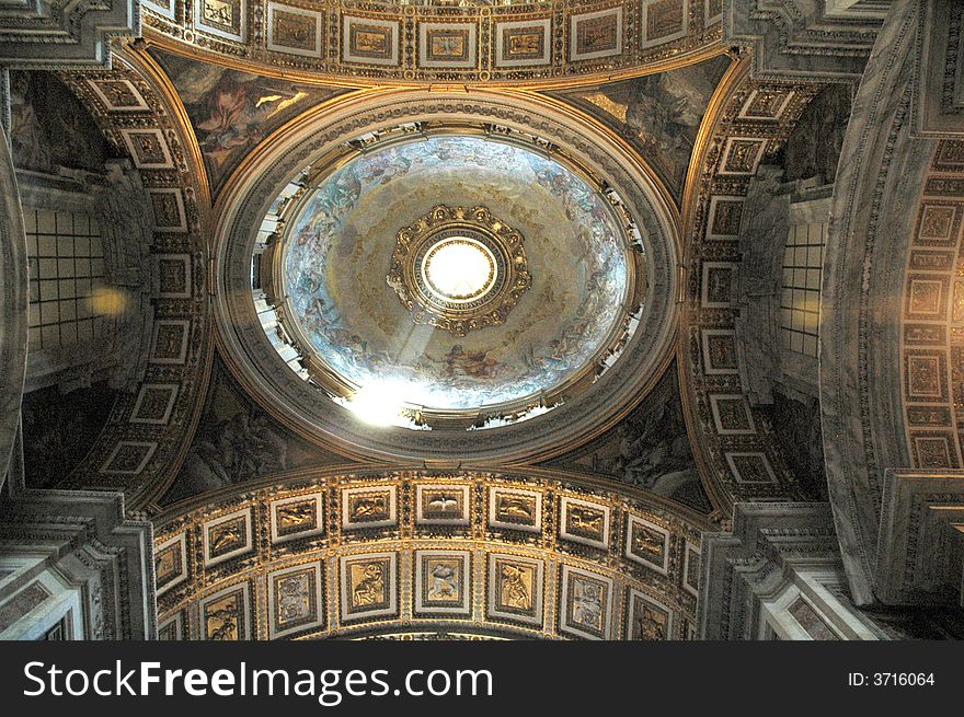 Interior of St.Pier cathedral dome with sun light coming from roof window. Vatican, Italy, EU