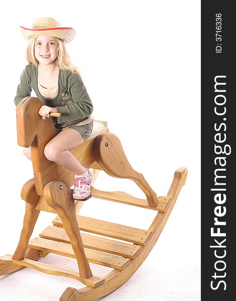 Little girl on rocking horse isolated on a white background