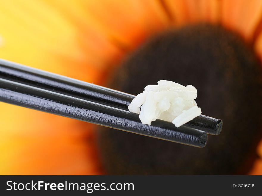 Chopsticks with rice against powerfull background. Chopsticks with rice against powerfull background