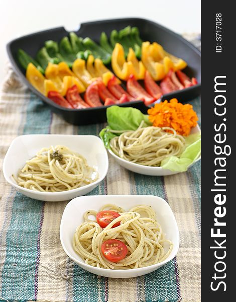 Assorted dishes of Pasta olio with multi colored rows of capsicums