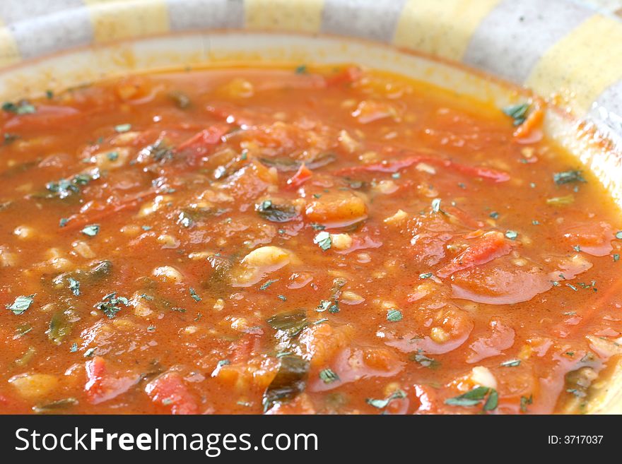 Chunky homemade tomato soup with chopped basil and garlic and a dash of olive oil