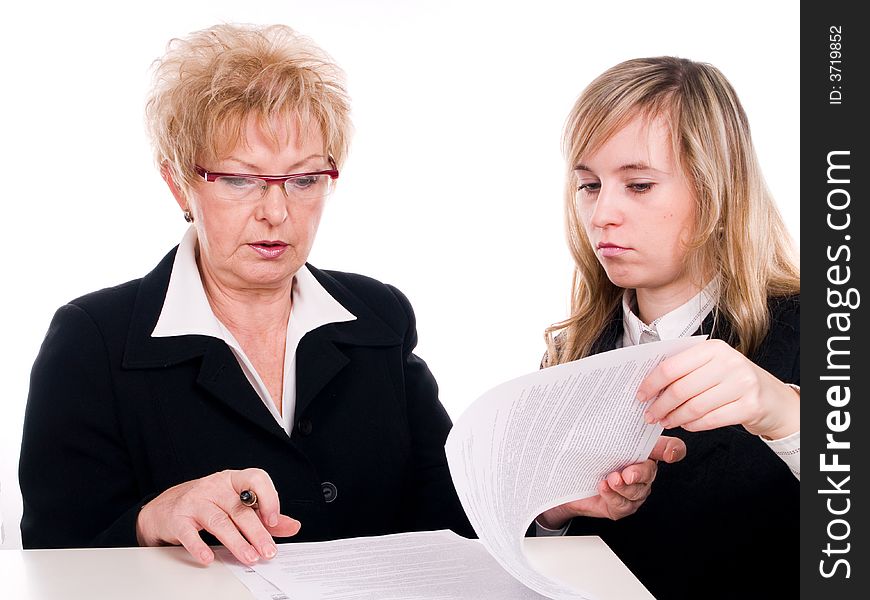 Businesswomen looking at important documents together. Businesswomen looking at important documents together