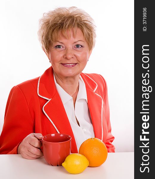 Blond woman with orange and hot beverage. Blond woman with orange and hot beverage