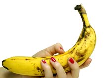 Banana In Female Hand Stock Photos
