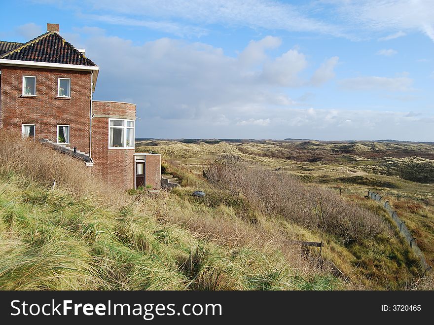 Dunes with house and grass