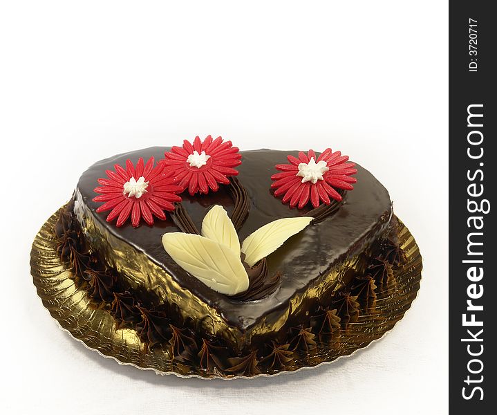 Individual chocolate cake with red flowers decoration