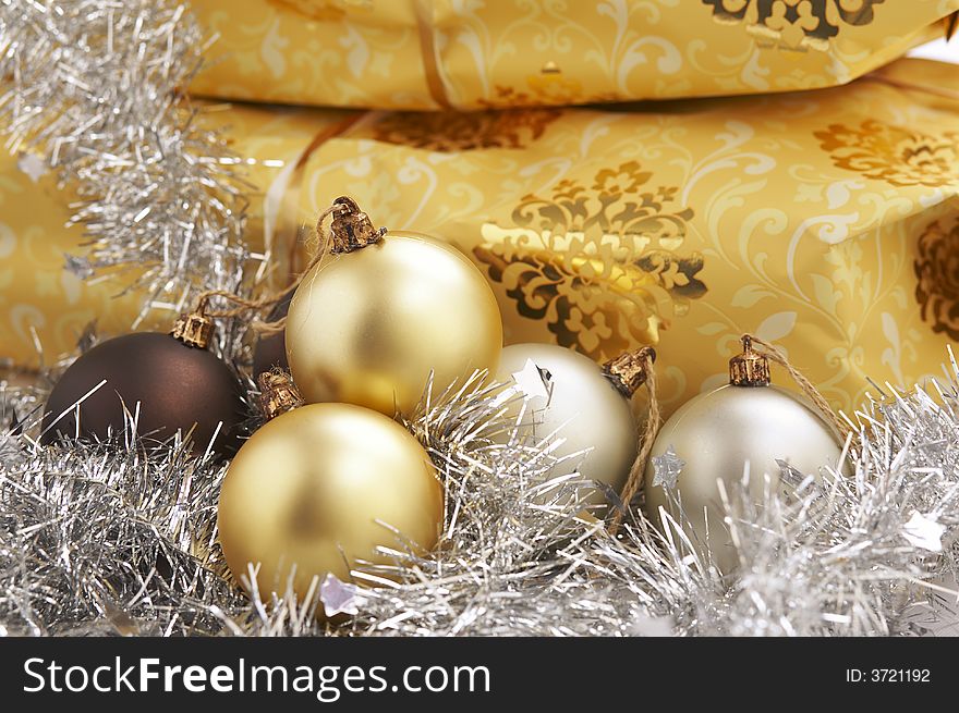 Christmas present on the table with golden and silver balls. Christmas present on the table with golden and silver balls