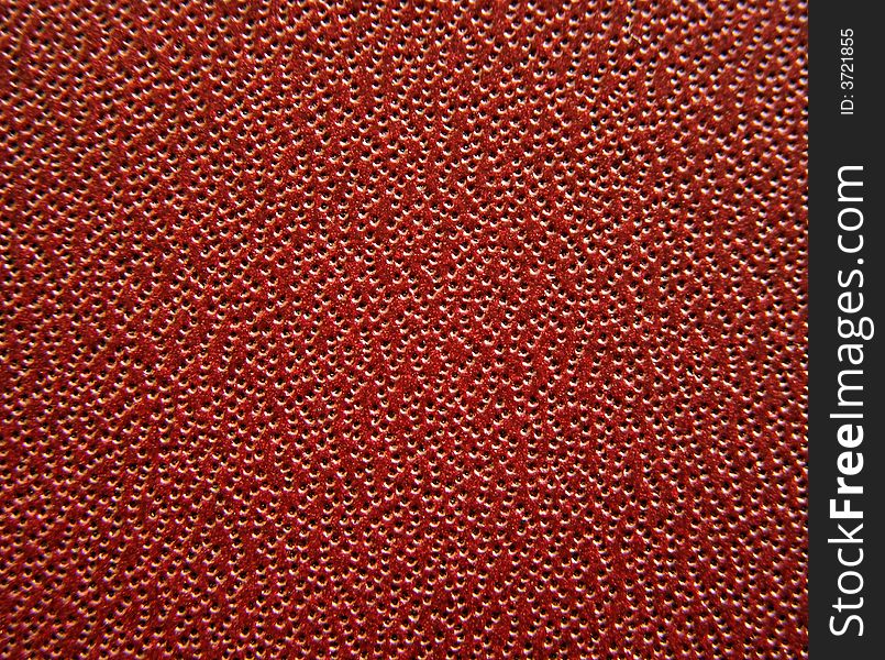 Macro background showing air holes in leather