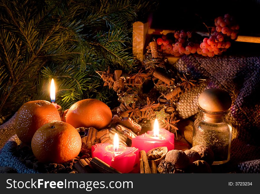 Christmas still-life - candles, mandarines, cookies, cones, nuts and spices. Low DOF, copy space on top.