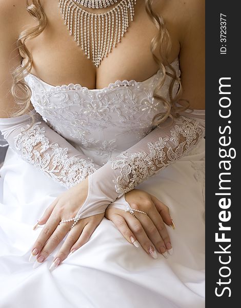 Beautiful bridal decollete - dress, gloves and necklace, and perfect manicure. Focus is on hands. Beautiful bridal decollete - dress, gloves and necklace, and perfect manicure. Focus is on hands.