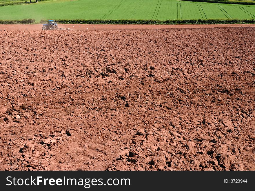 Tractor ploughing the land ready for seeding