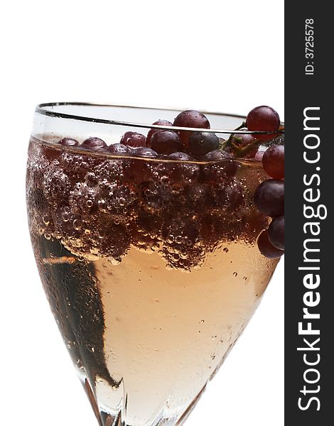 Champagne grapes in a glass of bubbly liquid. Champagne grapes in a glass of bubbly liquid