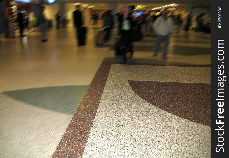 A blur of the hustle and bustle of travelers coming and going with the pattern on the floor providing a nice focal point to just off center of the image. - Mark Payne. A blur of the hustle and bustle of travelers coming and going with the pattern on the floor providing a nice focal point to just off center of the image. - Mark Payne