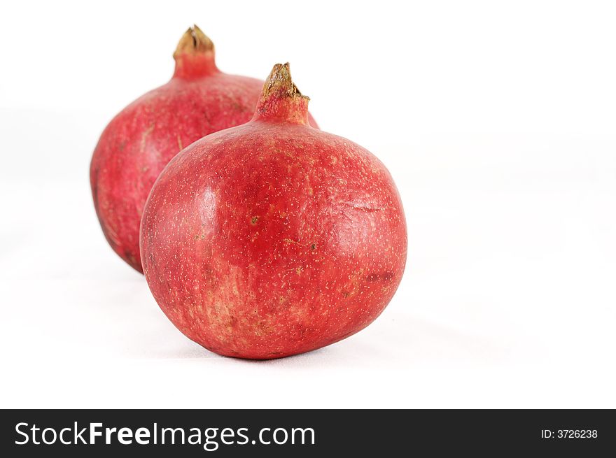 Two pomegranates on a white background