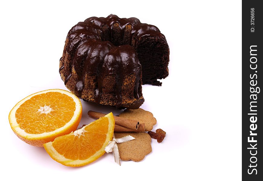 Poppy seed cake, oranges and cinnamon on the white background