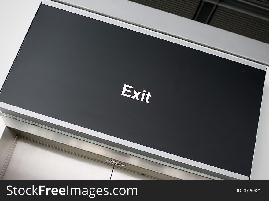 Just an Exit-sign on black board. Tilted.